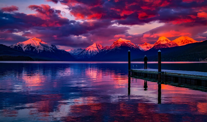 dock under cloudy sky in front of mountain